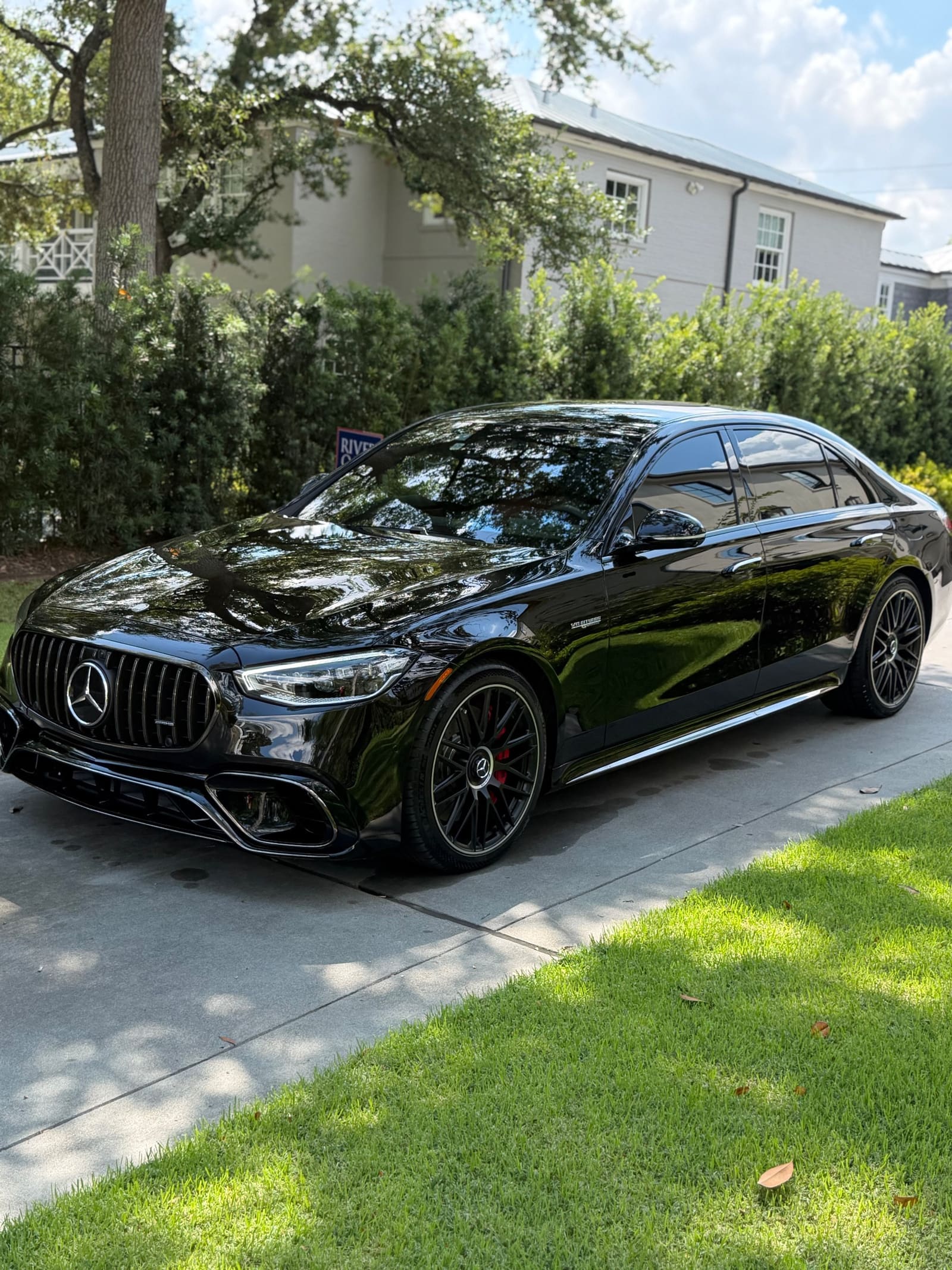 Black Mercedes-AMG S 63 on a driveway, paint polished to a mirror finish