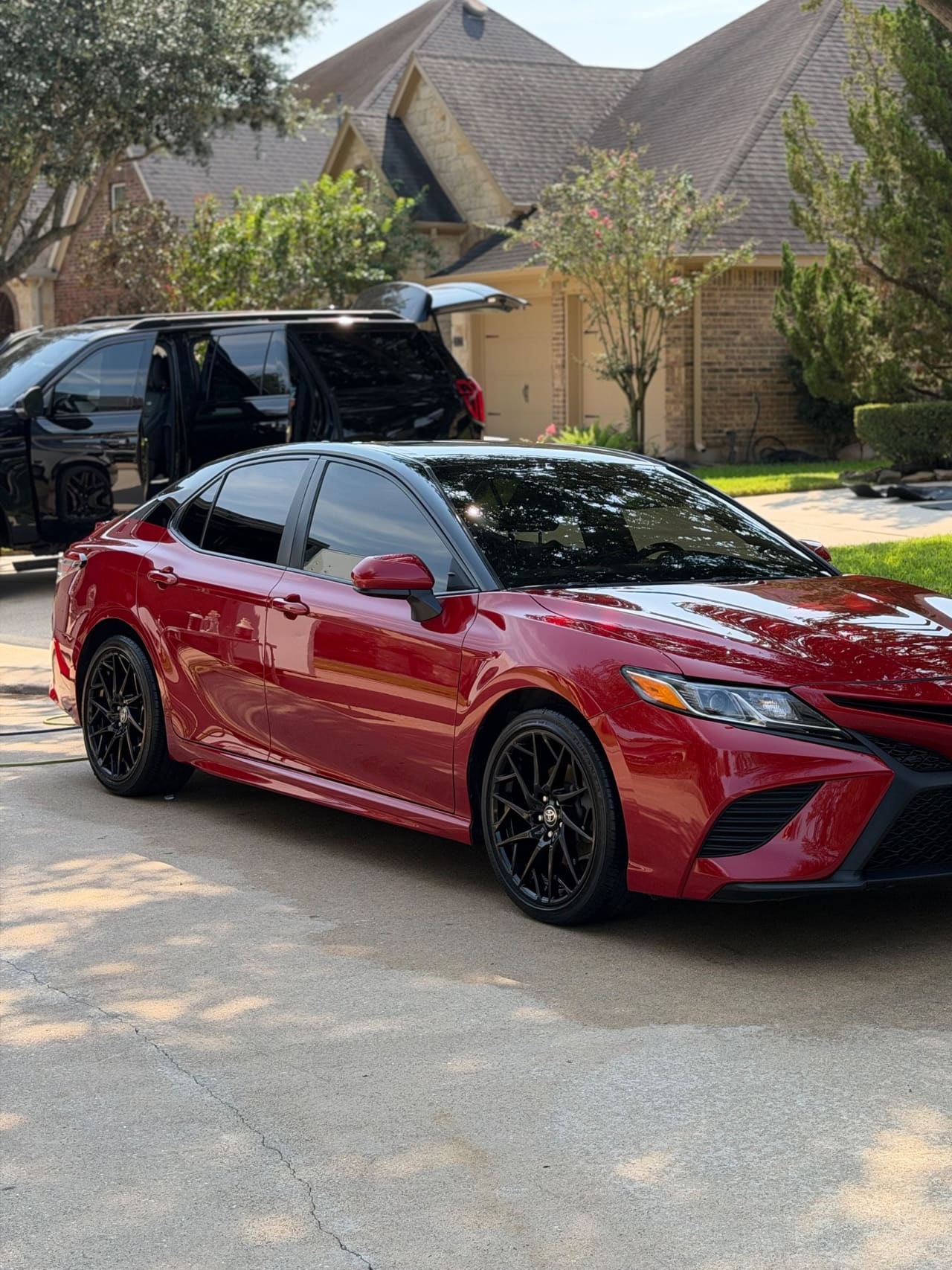 Red Toyota Camry on a driveway after an exterior detail