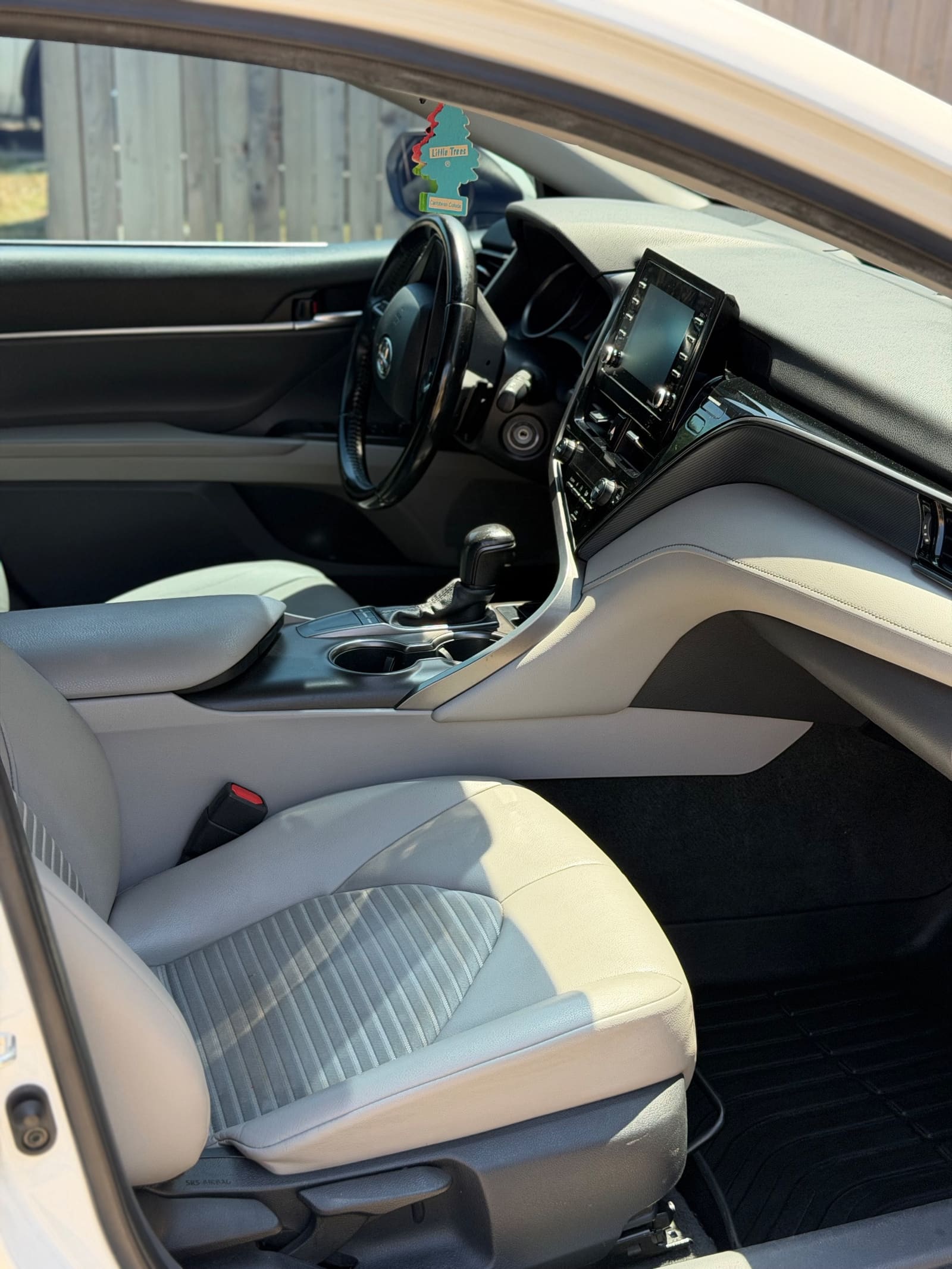 Cleaned front seats and console of a Toyota Camry after an interior detail